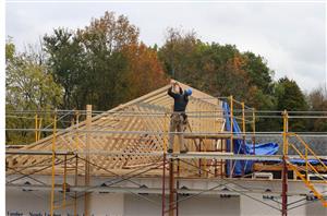 a Building Trades student works at the house project.
